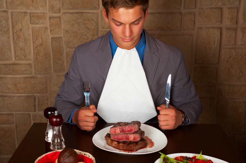 man eating meat