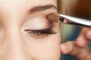 Woman applying Avon Eyeshadow